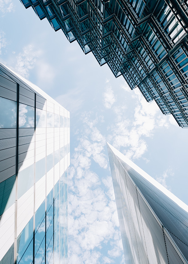 low angle vertical shot modern architectural buildings with cloudy blue sky